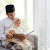 asian muslim father read quran with his daughter